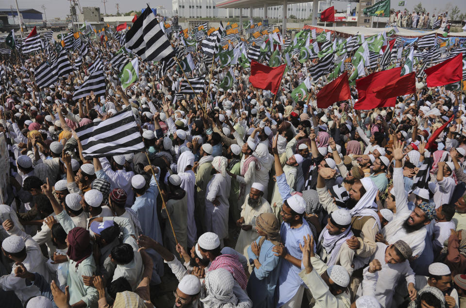 Supporters of the Jamiat Ulema-e-Islam party chant slogans while they gather to start an anti-government march, in Karachi, Pakistan, Sunday, Oct. 27, 2019. Thousands of supporters of the ultra-religious party are gathering in Karachi to start a large anti-government march on Pakistan's capital farther north. (AP Photo/Fareed Khan)