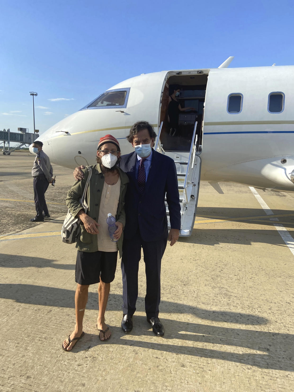 In this photo provided by the Richardson Center, former U.S. Ambassador to the U.N. Bill Richardson, right, poses with journalist Danny Fenster in Naypyitaw, Myanmar, Monday, Nov. 15, 2021. Richardson said in a statement Monday that Fenster had been released from prison and handed over to him in Myanmar and would be soon on his way home via Qatar. (The Richardson Center via AP)