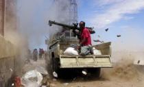 A Southern Popular Resistance fighter fires a weapon mounted on a truck during clashes with Houthi fighters in Yemen's southern city of Aden May 3, 2015. REUTERS/Stringer