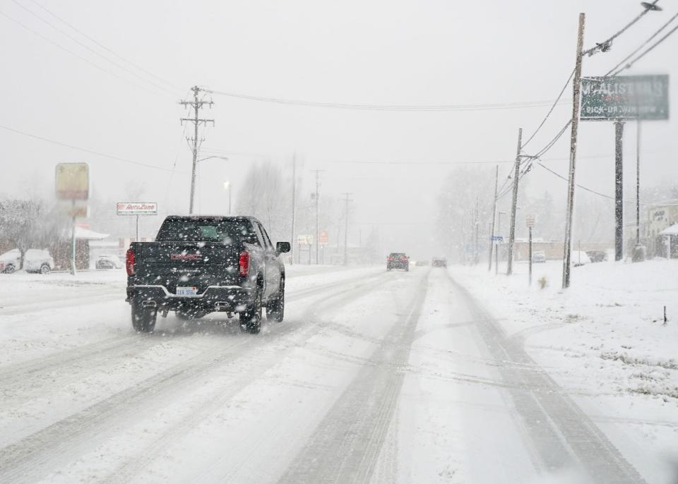 Traffic on South Main Street in Adrian moves through the falling snow Friday afternoon, Jan. 12, 2024.