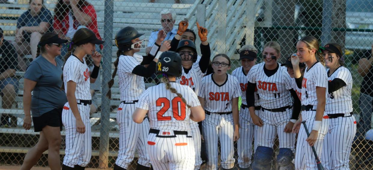 Sarasota teammates greet Brooke Bendel as she arrives at home plate after hitting her 10th home run of the season, a solo shot against Mitchell during the Class 6A regional semifinal Thursday night at the Sailors field.