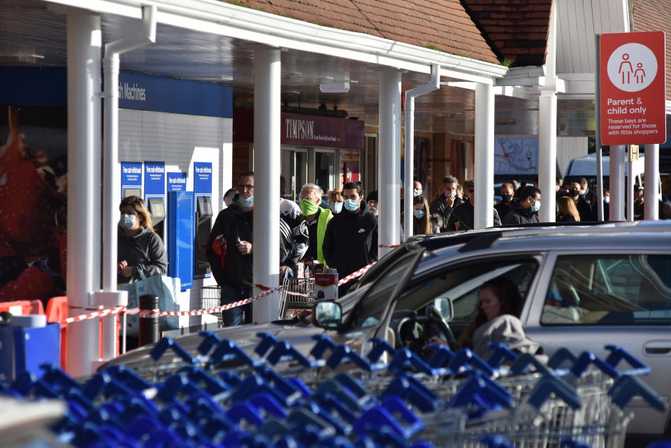 SOUTHEND, ENGLAND - DECEMBER 20: People start to queue at Tesco supermarket as Essex goes into tier 4 on December 20, 2020 in Southend on Sea, England. As from today all non essential shops and retailers will close in areas including London, Kent, Essex and Bedfordshire. People in tier four can now not mix indoors with anyone not from their household. (Photo by John Keeble/Getty Images)