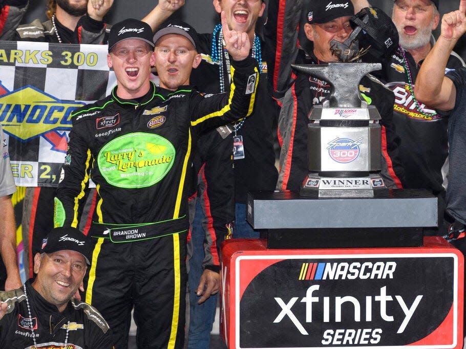 Brandon Brown celebrates in Victory Lane after winning a NASCAR Xfinity Series auto race Saturday, Oct. 2, 2021, in Talladega, Ala.