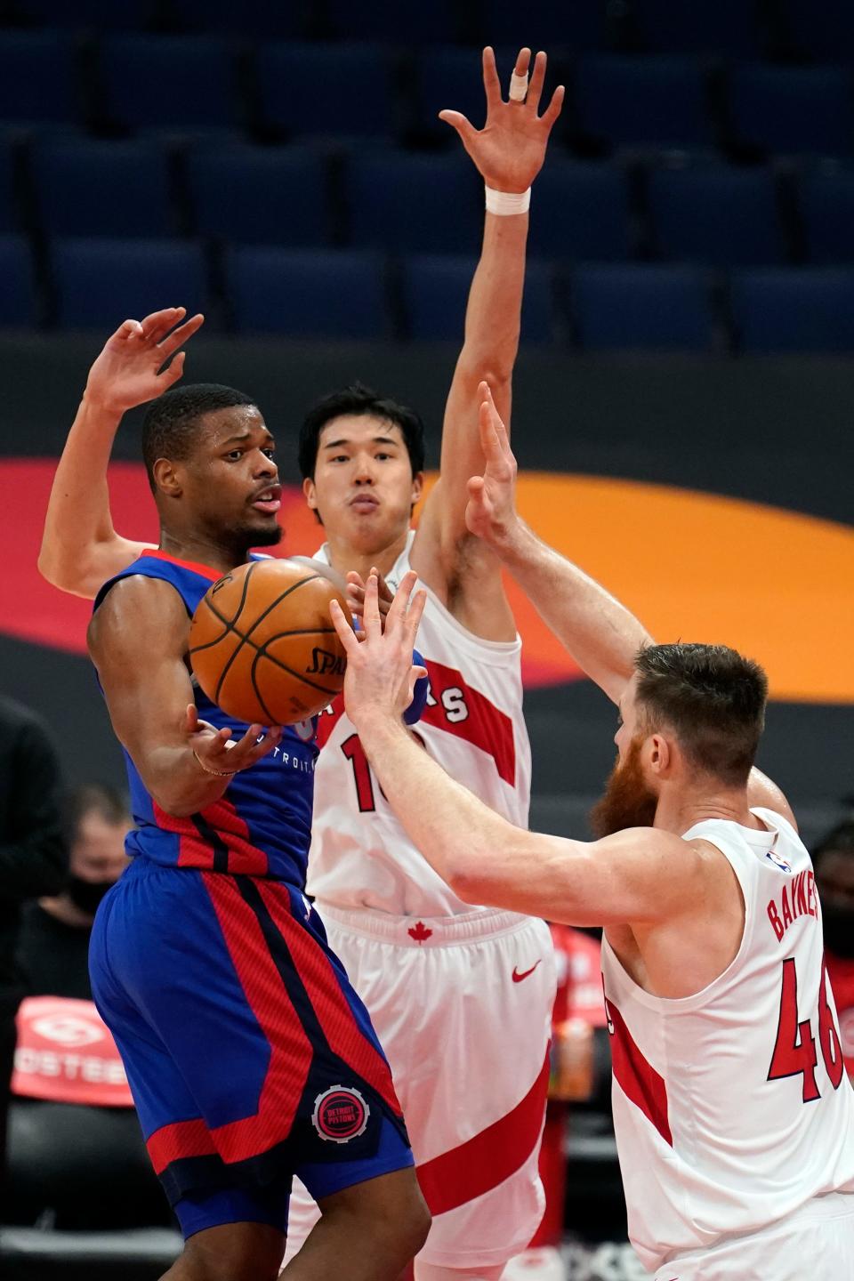 Pistons guard Dennis Smith Jr. loses the ball as he tries to get around Raptors forward Yuta Watanabe, center, and center Aron Baynes during the first half in Tampa, Florida, on Wednesday, March 3, 2021.