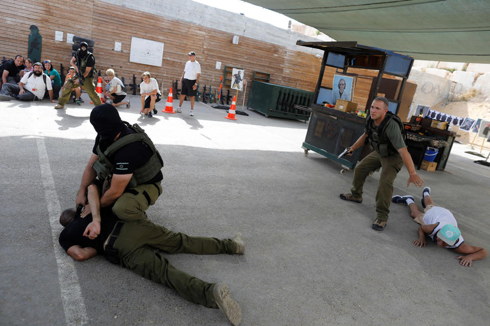 <p>A group of tourists watch as Israeli instructors demonstrate during a two hour “boot camp” experience, at “Caliber 3 Israeli Counter Terror and Security Academy” in the Gush Etzion settlement bloc south of Jerusalem in the occupied West Bank July 13, 2017. (Photo: Nir Elias/Reuters) </p>