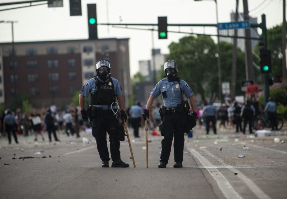 Two police officers stand outside the Third Police Precinct during the ‘I Can’t Breathe’ protest on May 27, 2020 in Minneapolis, Minnesota. (Photo by Stephen Maturen/Getty Images)