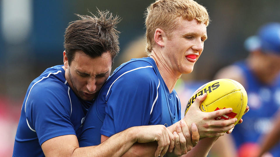 Red Og Murphy, pictured here with Sam Wright at a North Melbourne training session in 2019.