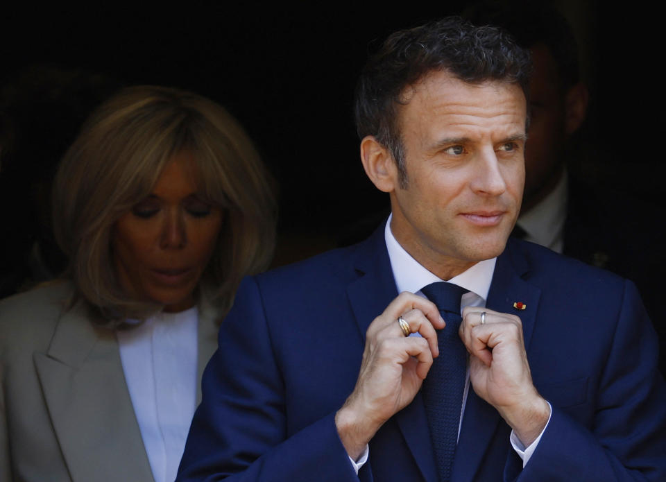 French President and centrist candidate for reelection Emmanuel Macron and his wife Brigitte Macron leave after voting in Le Touquet, northern France, Sunday, April 24, 2022. France began voting in a presidential runoff election Sunday with repercussions for Europe's future, with centrist incumbent Emmanuel Macron the front-runner but fighting a tough challenge from far-right rival Marine Le Pen. (Gonzalo Fuentes; Pool via AP)