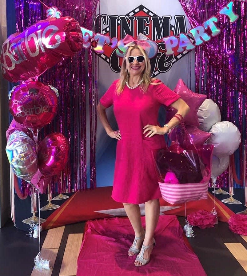 The Social Butterfly columnist Kristi K. Higgins wears a Barbie-inspired outfit to watch the summer blockbuster film Barbie at Cinema Cafe in Chester, Va. on July 29, 2023.