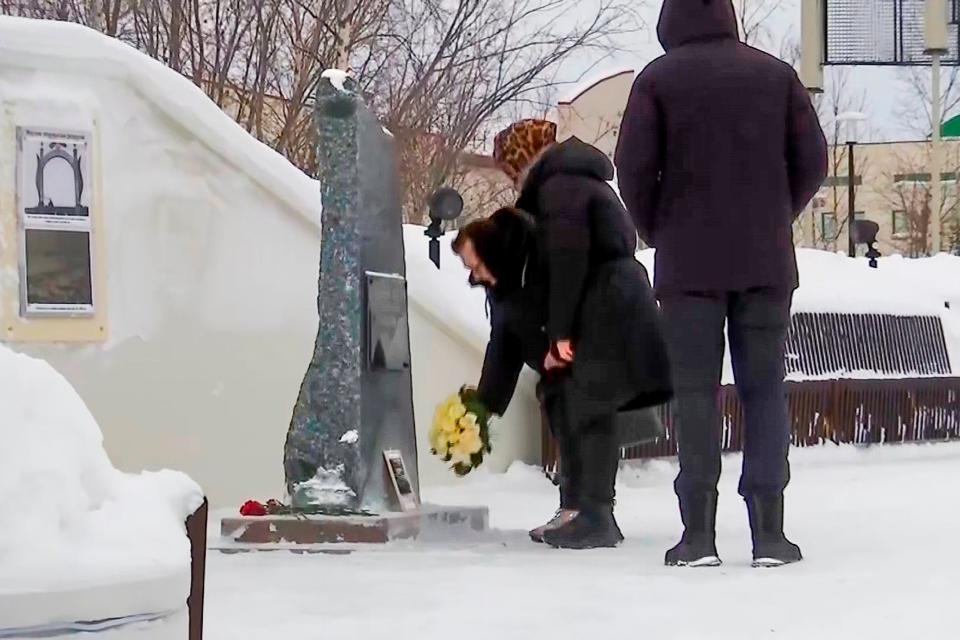 In this grab taken from video, Lyudmila Navalnaya, mother of Russian opposition leader Alexei Navalny, center, pay tribute to her son Alexei Navalny at the at the memorial to victims of political repression, in Salekhard (AP)