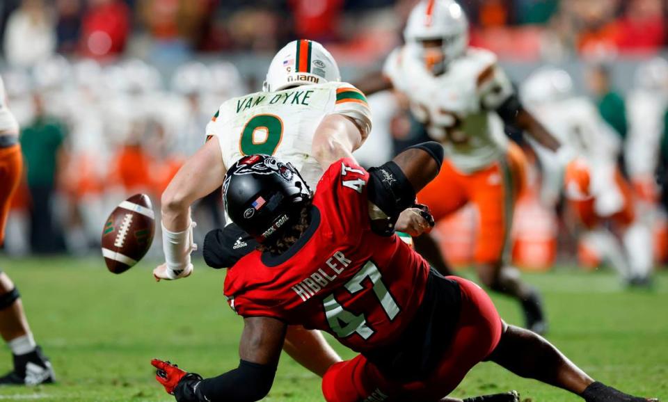 N.C. State defensive lineman Red Hibbler (47) sacks Miami quarterback Tyler Van Dyke (9) forcing a fumble during the first half of N.C. State’s game against Miami at Carter-Finley Stadium in Raleigh, N.C., Saturday, Nov. 4, 2023.