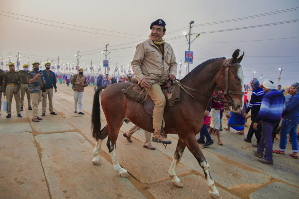 Inspector General of Police Kavinder Pratap Singh patrols on horseback during Magh Mela festival, in Prayagraj, India. Tuesday, Feb. 16, 2021. Millions of people have joined a 45-day long Hindu bathing festival in this northern Indian city, where devotees take a holy dip at Sangam, the sacred confluence of the rivers Ganga, Yamuna and the mythical Saraswati. Here, they bathe on certain days considered to be auspicious in the belief that they be cleansed of all sins. (AP Photo/Rajesh Kumar Singh)