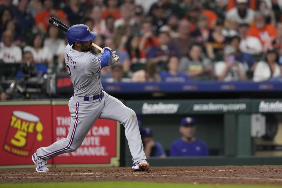 Texas Rangers' Marcus Semien hits a grand slam against the Houston Astros during the seventh inning of a baseball game Sunday, April 16, 2023, in Houston. (AP Photo/David J. Phillip)