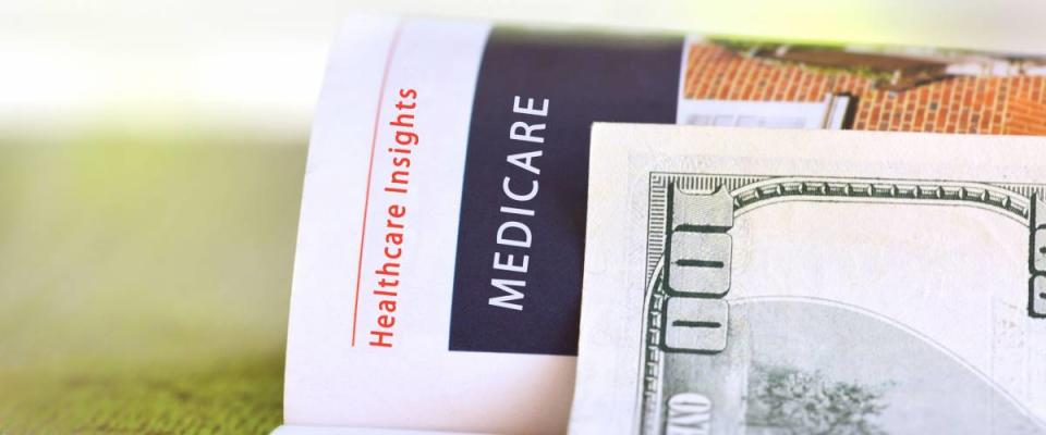 Medicare paper headline with  hundred dollar bill