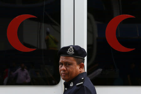 A Malaysian police officer walks near the morgue at Kuala Lumpur General Hospital where Kim Jong Nam's body is held for autopsy in Malaysia February 21, 2017. REUTERS/Athit Perawongmetha