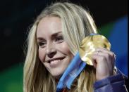 FILE - In this Feb. 17, 2010, file photo, Lindsey Vonn of the United States, shows the gold medal she won in the women's downhill ski race during the medal ceremony at the Vancouver 2010 Olympics in Whistler, British Columbia. Vonn announced Friday, Feb. 1, 2019, that she will retire from ski racing after this month's world championships in Sweden. (AP Photo/Luca Bruno, File)