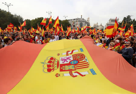 Demonstrators wave Spanish flags and shout in front of city hall during a demonstration in favor of a unified Spain a day before a banned October 1 independence referendum in Catalonia, in Madrid, Spain, September 30, 2017. REUTERS/Sergio Perez