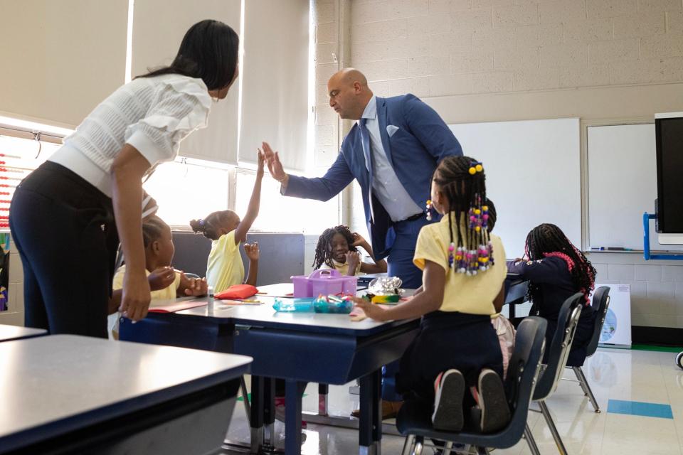 Detroit Public School Community District Superintendent Nicolai Vitti high-fives a student on the first day of school on Monday, Aug. 28, 2023, in Detroit.