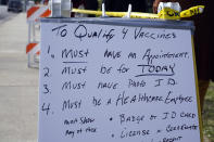 A sign describes the requirements to receive a COVID-19 vaccine at a site for health care workers at Ritchie Valens Recreation Center Wednesday, Jan. 13, 2021, in Pacoima, Calif. (AP Photo/Marcio Jose Sanchez)