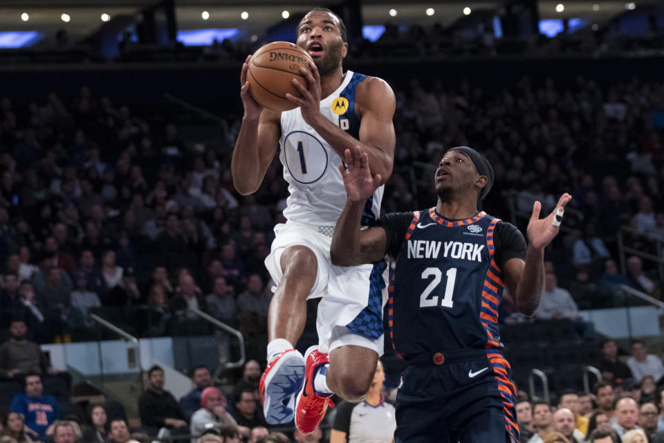 Indiana Pacers forward T.J. Warren (1) goes to the basket past New York Knicks guard Damyean Dotson (21) in the first half of an NBA basketball game, Saturday, Dec. 7, 2019, at Madison Square Garden in New York. (AP Photo/Mary Altaffer)