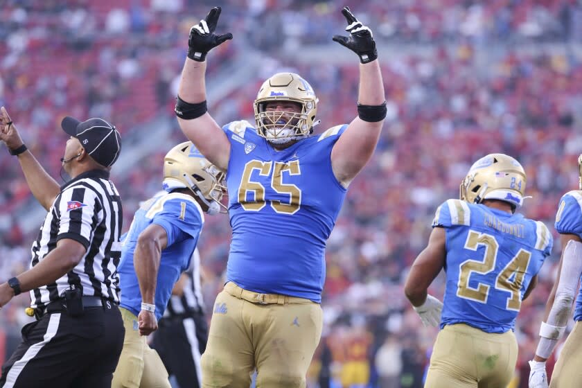 Los Angeles, CA - November 20: UCLA offensive lineman Paul Grattan, Jr., center, celebrates.