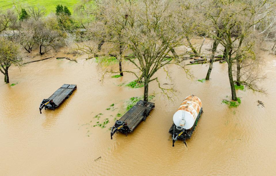 Trailers sit in a flooded field in Petaluma, California, on February 4, 2024. The US West Coast was getting drenched on February 1 as the first of two powerful storms moved in, part of a u0022Pineapple Expressu0022 weather pattern that was washing out roads and sparking flood warnings. The National Weather Service said u0022the largest storm of the seasonu0022 would likely begin on February 4.