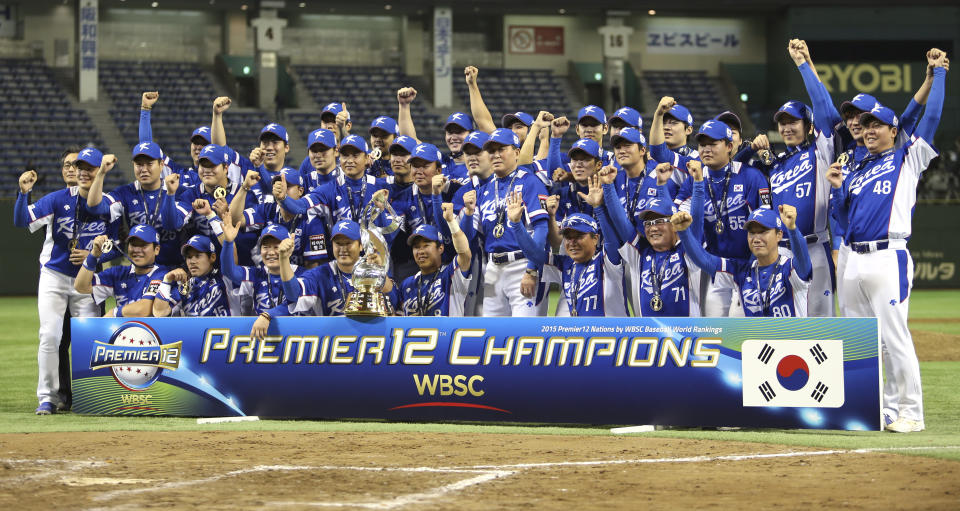 FILE - South Korea's players and team staff pose for a group photo during an award ceremony after beating USA 8-0 in their final game at the Premier12 world baseball tournament at Tokyo Dome in Tokyo, Japan, on Nov. 21, 2015. (AP Photo/Toru Takahashi, File)