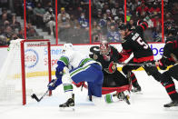 Vancouver Canucks' right wing Alex Chiasson (39) pokes the puck past Ottawa Senators goaltender Filip Gustavsson during the third period of an NHL hockey game, Wednesday, Dec.1, 2021 in Ottawa, Ontario. (Sean Kilpatrick/The Canadian Press via AP)