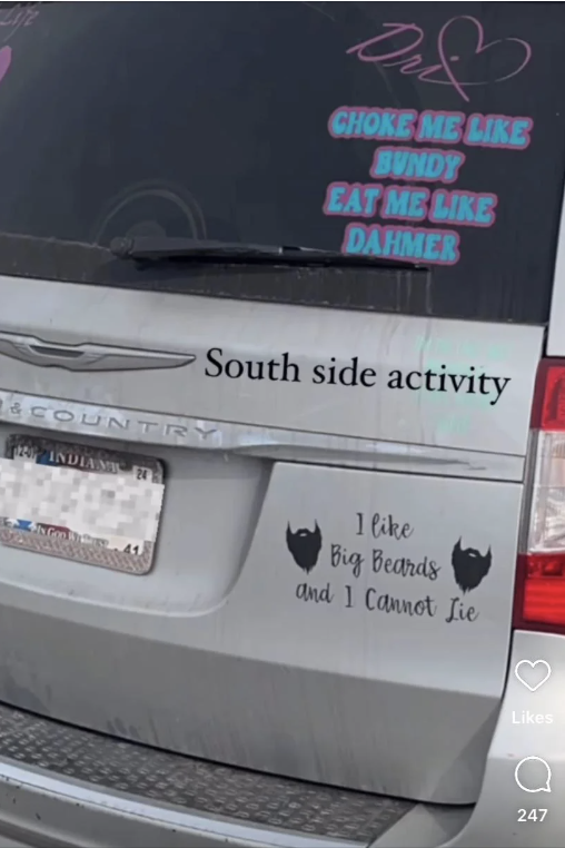 Rear view of a car with multiple bumper stickers containing dark humor references