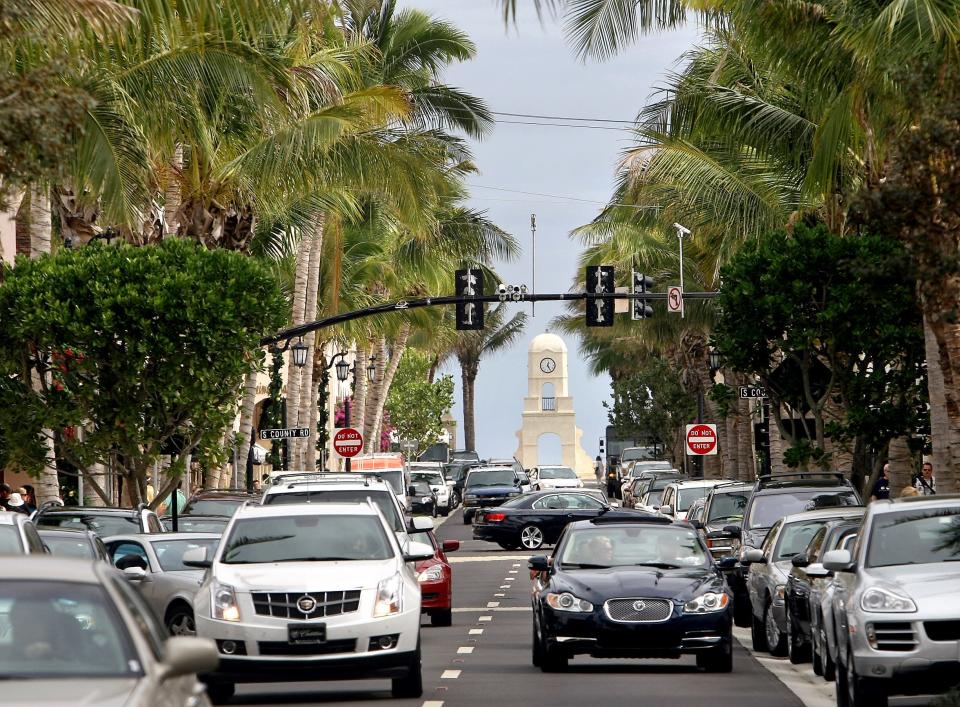 Looking east on Worth Avenue toward the clock tower. Some of the 200 coconut palms that line the street are visible.