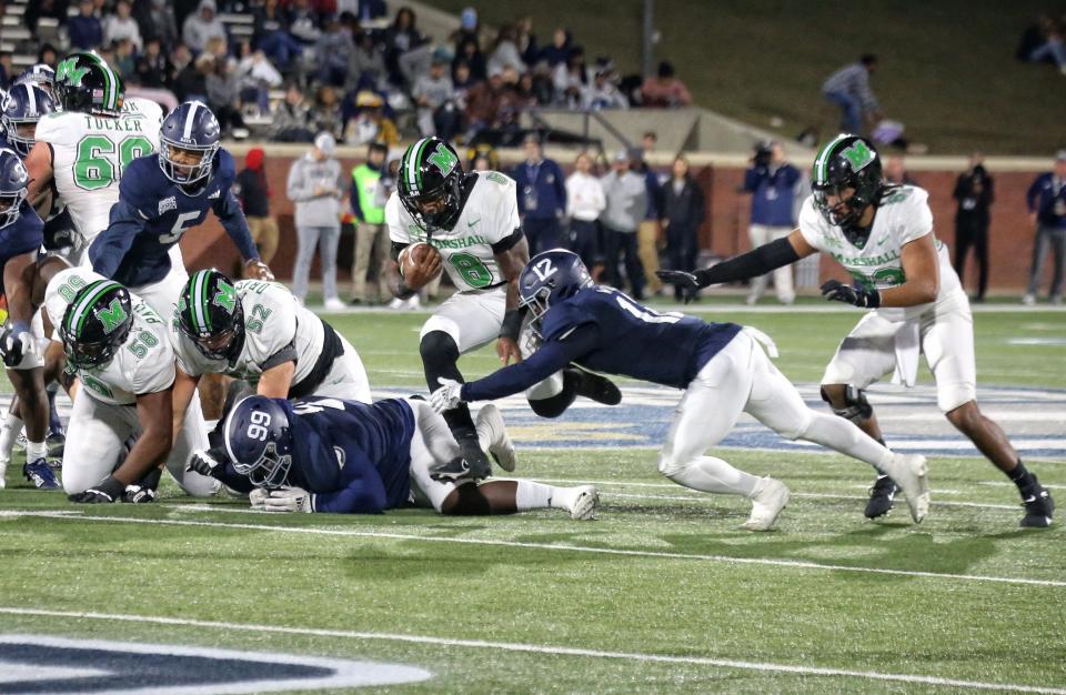 Marshall running back Khalan Laborn runs past Georgia Southern safety Anthony Wilson (12) on Saturday night at Paulson Stadium in Statesboro.