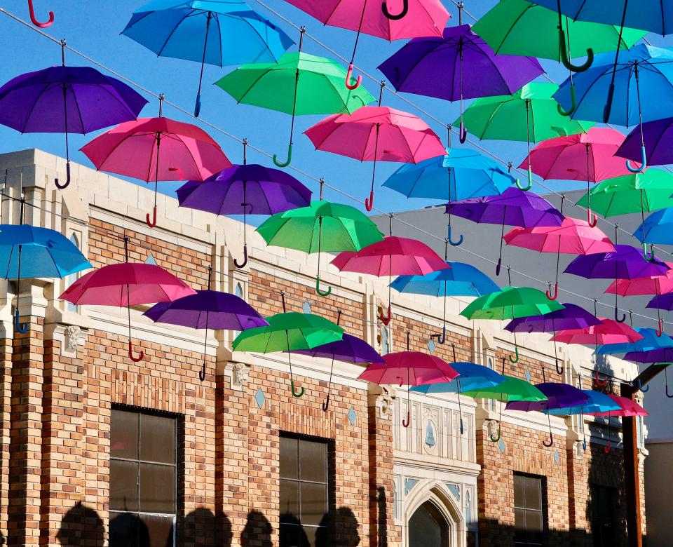 The late-afternoon sun illuminates umbrellas suspended in Umbrella Alley between Yuba and Placer streets where the State of the City presentation was given Friday, Sept. 23, 2022.