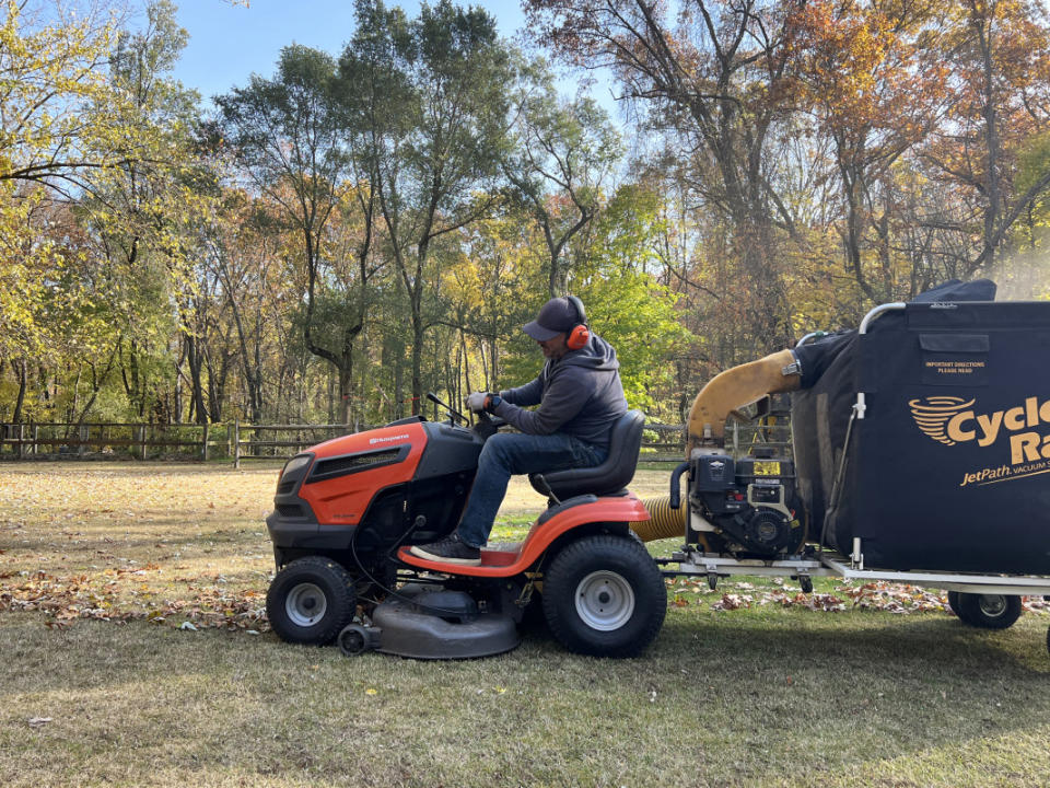 A lawn mower pulls a <span>Cyclone Rake</span> to collect leaves in the fall before being winterized for the season.<p>Emily Fazio</p>