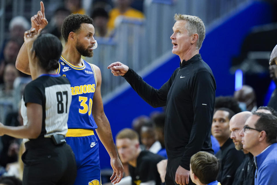 Golden State Warriors guard Stephen Curry (30) talks to head coach Steve Kerr during the first half of an NBA basketball game against the San Antonio Spurs in San Francisco, Monday, Nov. 14, 2022. (AP Photo/Godofredo A. Vásquez)