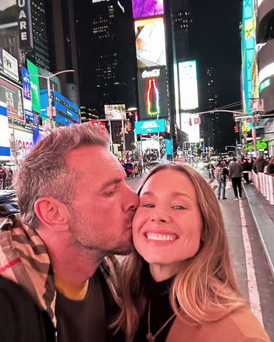 <p>Dax Shepard/Instagram</p> Dax Shepard kisses wife Kristen Bell on the cheek in Times Square.