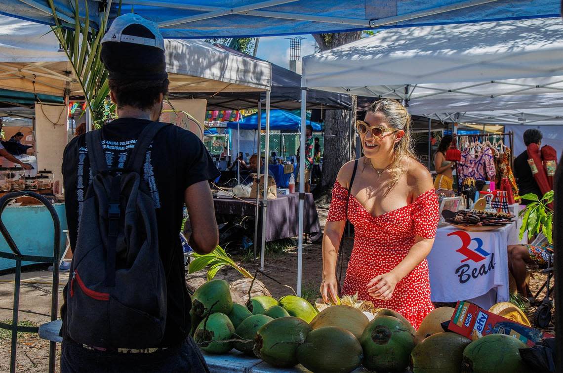 Kobe Rowlins sells a coconut to Gabriela Palau.
