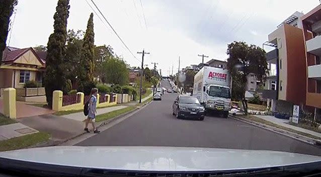 Dashcam footage shows a distracted schoolgirl failing to look both ways before crossing the road. Picture: YouTube/Jeffrey Cheng