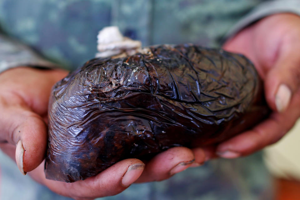 Poppy farmer Santiago Sanchez holds opium paste