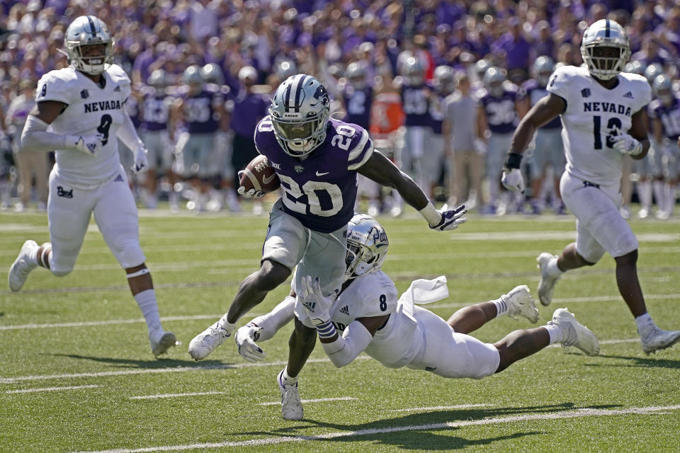 Kansas State running back Joe Ervin (20) gets past Nevada defensive back JoJuan Claiborne (8) to score a touchdown during the first half of an NCAA college football game Saturday, Sept. 18, 2021, in Manhattan, Kan. (AP Photo/Charlie Riedel)