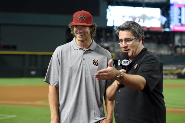 PHOENIX, AZ - JUNE 25: Phoenix Coyotes goaltender Mike Smith talks baseball with Fox Sports Arizona's Todd Walsh prior to a game between the Arizona Diamondbacks and the Cleveland Indians at Chase Field on June 25, 2014 in Phoenix, Arizona. (Photo by Norm Hall/Getty Images)