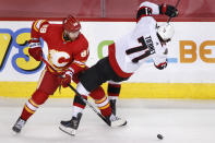 Ottawa Senators' Chris Tierney, right, is knocked off the puck by Calgary Flames' Nikita Nesterov during the third period of an NHL hockey game Sunday, May 9, 2021, in Calgary, Alberta. (Larry MacDougal/The Canadian Press via AP)