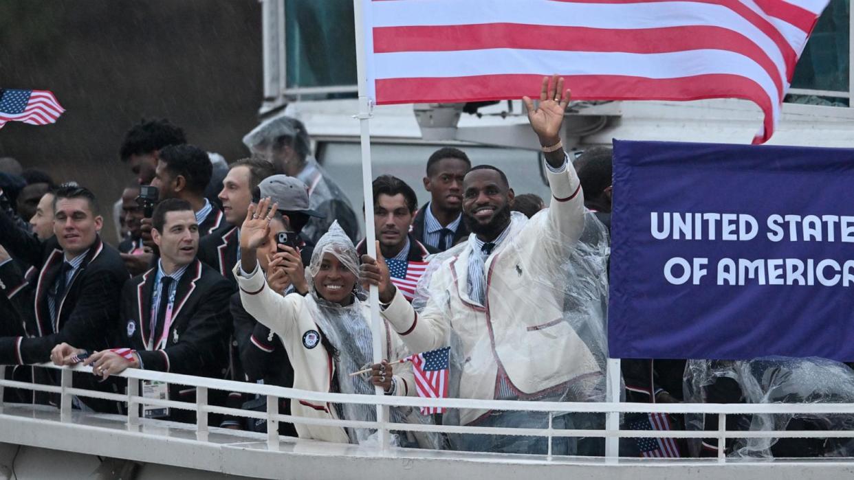 PHOTO: U.S.A. flag bearers Coco Gauff and Lebron James are seen at the opening ceremony of the Summer Olympics, July 26, 2024, in Paris.  (Sina Schuldt/Picture Alliance via Getty Images)