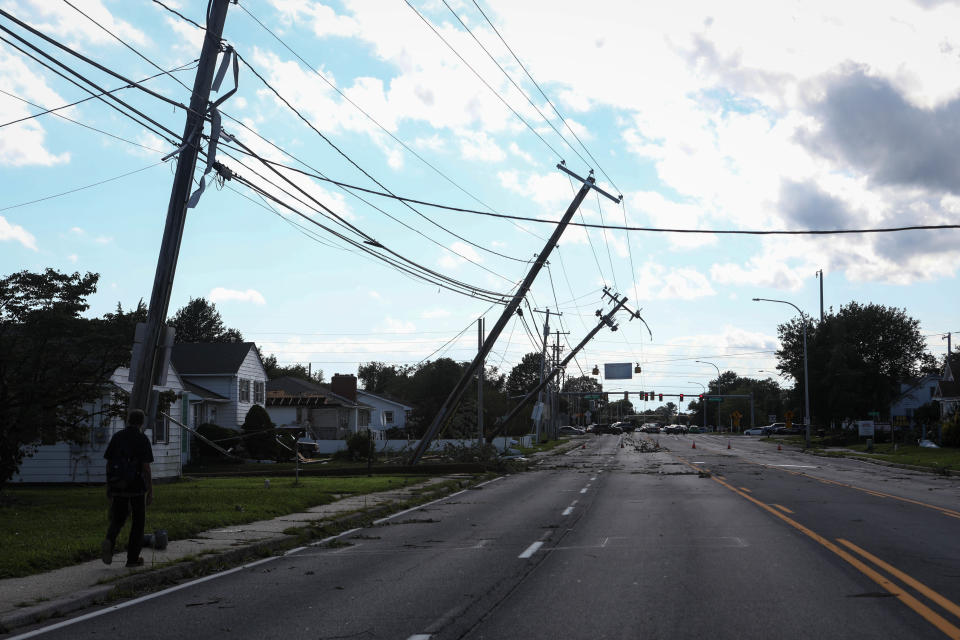 Power lines hung in the street and broken trees dotted yards on Division Street in Dover after storms blew through the area on Tuesday, August 4, 2020.
