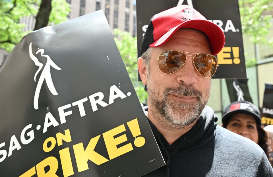 US actor Jason Sudeikis joins members of the Writers Guild of America and the Screen Actors Guild as they walk a picket line outside NBC Universal in New York City on July 14, 2023. Tens of thousands of Hollywood actors went on strike at midnight July 13, 2023, effectively bringing the giant movie and television business to a halt as they join writers in the first industry-wide walkout for 63 years.