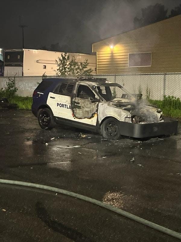 Pictured is a blue and white Portland Police Bureau vehicle with metal training wraparound PIT bumper burned.