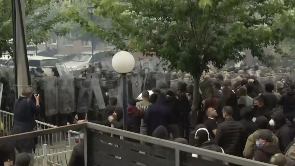 In this grab taken from video, KFOR soldiers guard a municipal building after clashes with Kosovo Serbs in the town of Zvecan, northern Kosovo, Monday, May 29, 2023. (AP)