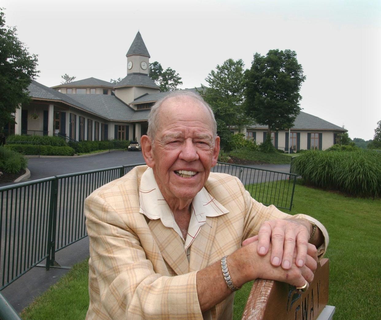 Pictured in 2004, Dwight Gahm, founder of Valhalla Golf, with the Valhalla clubhouse behind him. Gahm, then 85, sold Valhalla Golf Club in 1996 but still played the course four times a week. "Every year, I appreciate it a little more," he said.