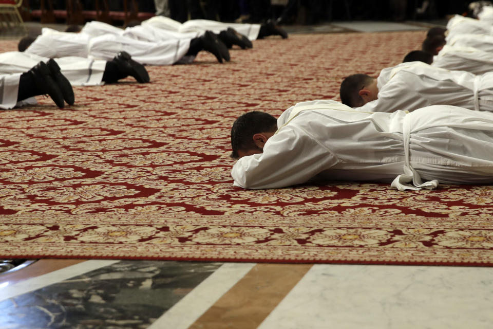 Priests lie face down on the floor during an ordination ceremony presided over by Pope Francis, in St.Peter's Basilica at the Vatican, Sunday, May 12, 2019. (AP Photo/Alessandra Tarantino)