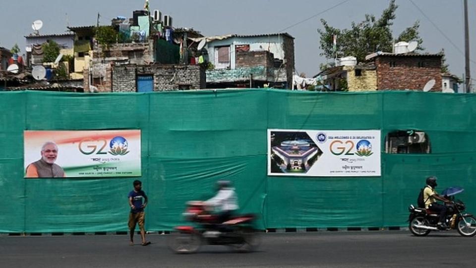 A man walks past G20 India summit hoardings along a street in New Delhi on September 5, 2023, ahead of its commencement. (