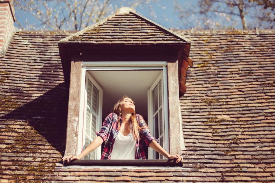 Woman looking through a window